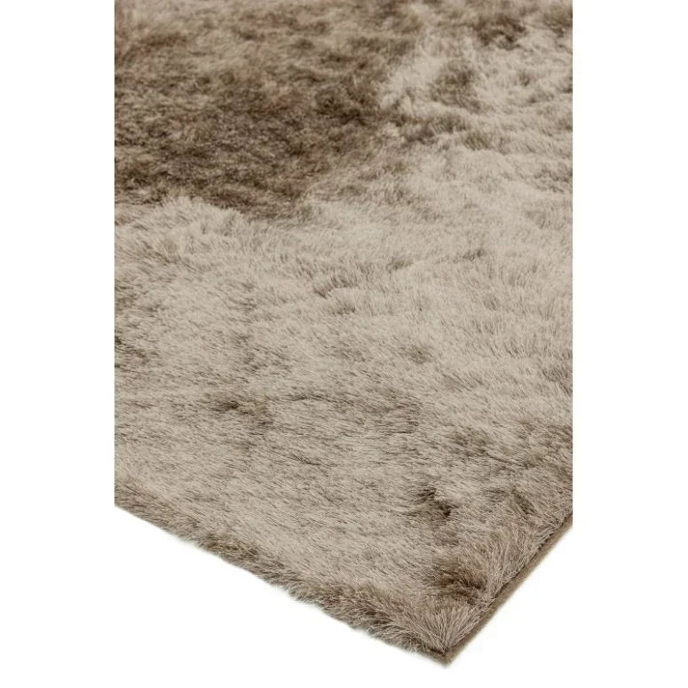 Close-up of beige shaggy rug corner with soft pile texture