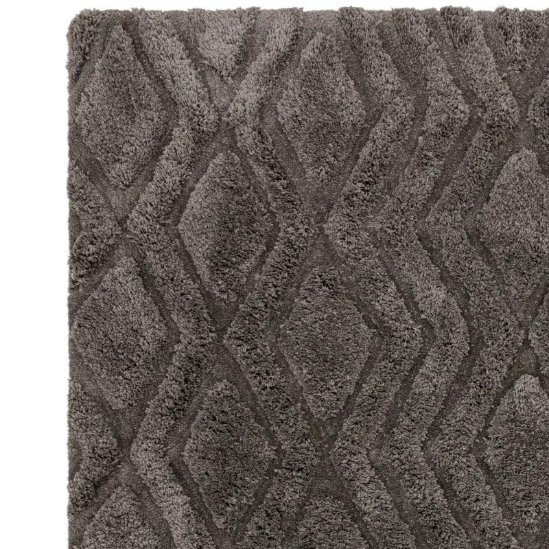 Grey shaggy rug with diamond pattern and soft textured pile, corner view