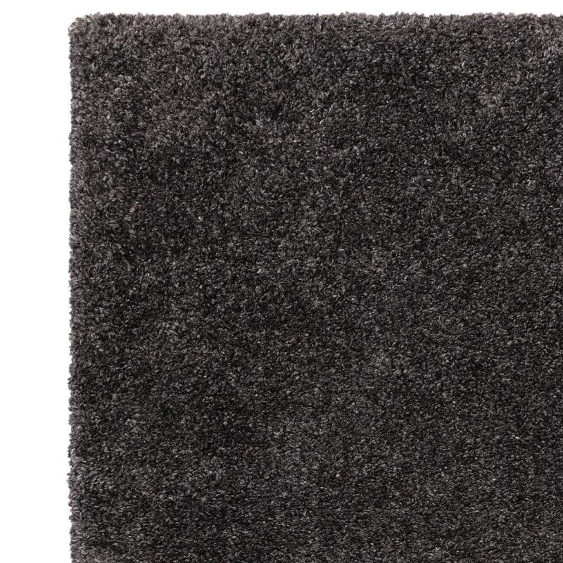 Close-up of dark grey shaggy rug with thick pile texture