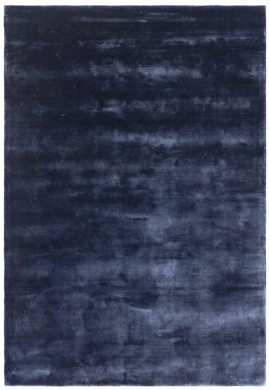 Large rectangular navy blue area rug with soft, plush texture and subtle tonal pattern