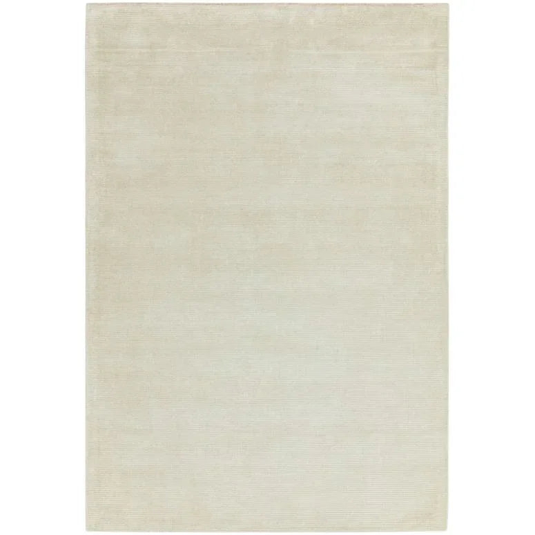 Large rectangular beige area rug with subtle textured pattern on flat surface