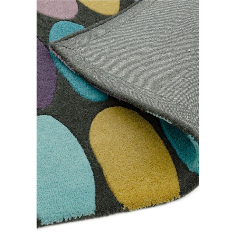 Detail of multicoloured patterned rug with blue, yellow, and purple oval shapes