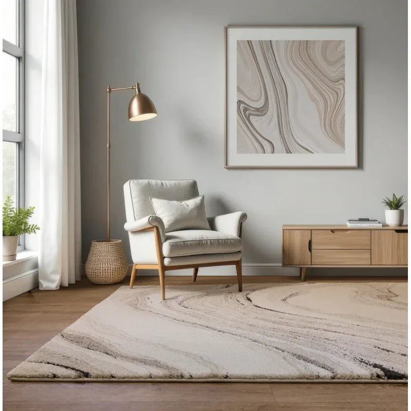 Modern beige and cream area rug in living room with armchair, wooden sideboard, and artwork