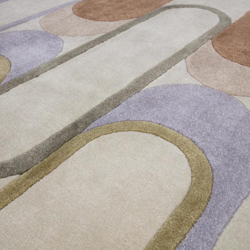 Modern area rug with geometric pattern in beige, lavender, and brown tones
