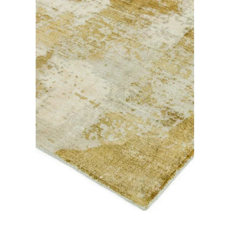 Beige and gold area rug with abstract pattern, close-up of textured corner