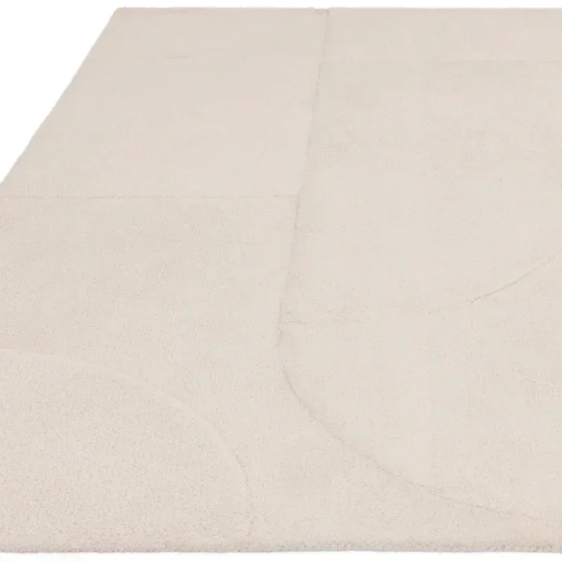 Large cream rug with subtle geometric pattern and soft texture