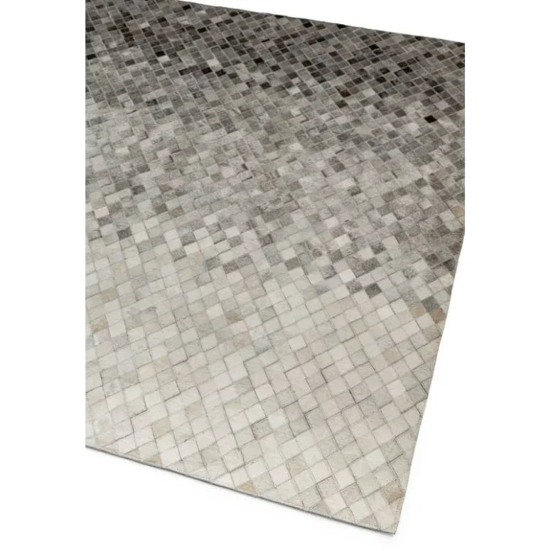 Grey and white patchwork area rug with small square pattern, corner angle view