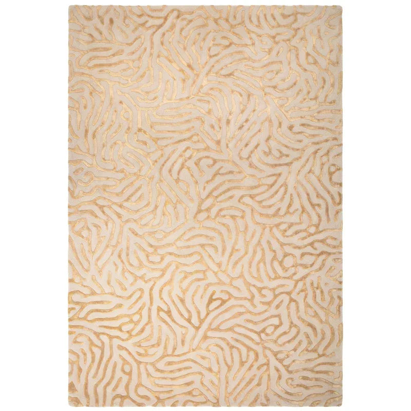 Beige and gold patterned area rug with raised abstract design, rectangular shape