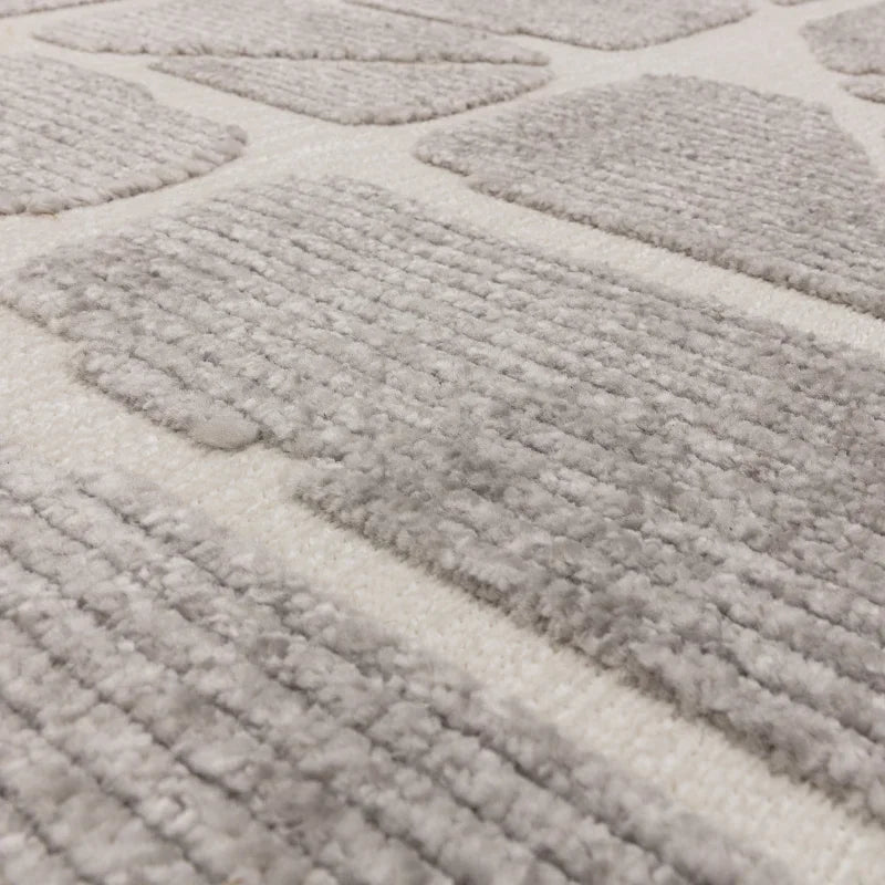 Close-up of textured grey and cream geometric rug pile