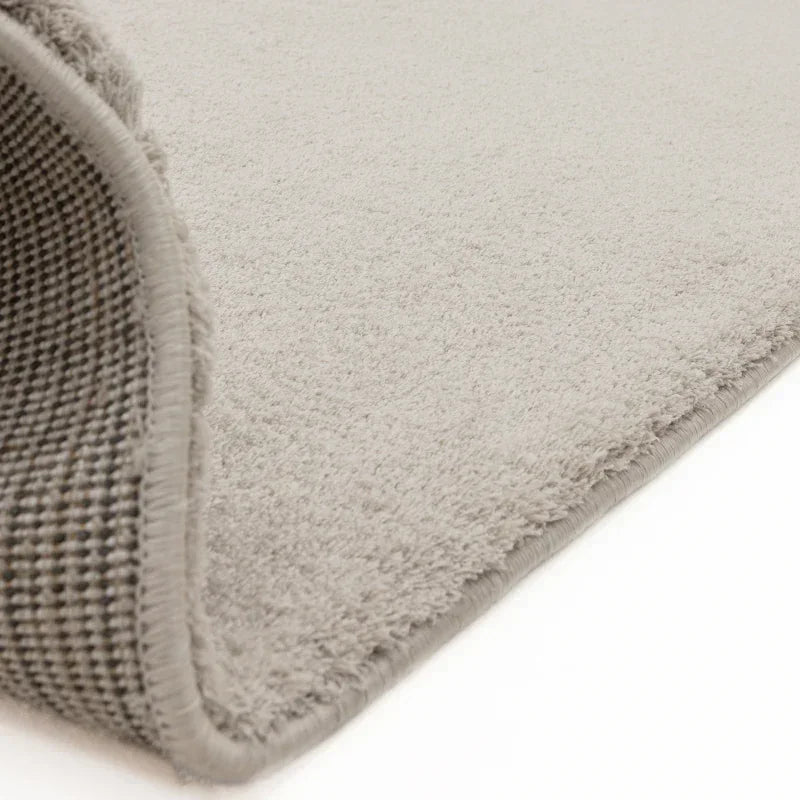 Light grey rug close-up showing soft pile and textured backing