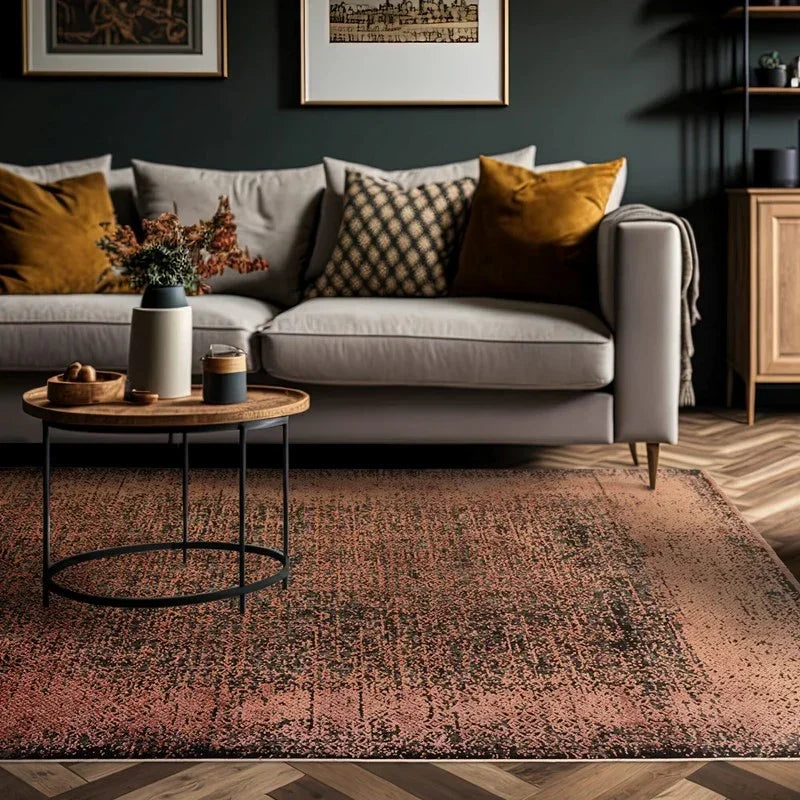 Modern sofa with ochre cushions, round wood coffee table, abstract rug in living room