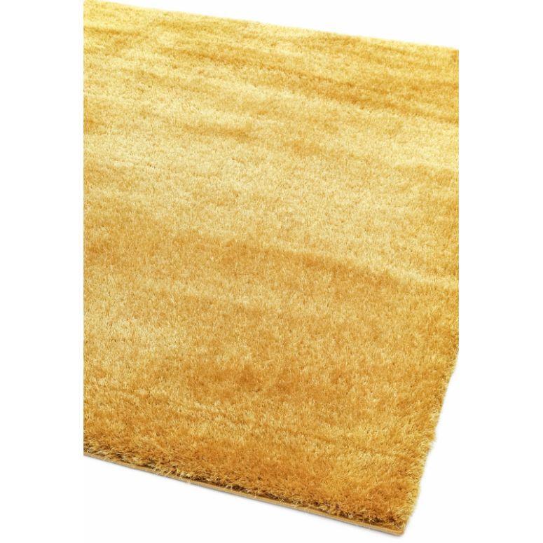Yellow shaggy rug with soft high-pile texture shown from corner angle