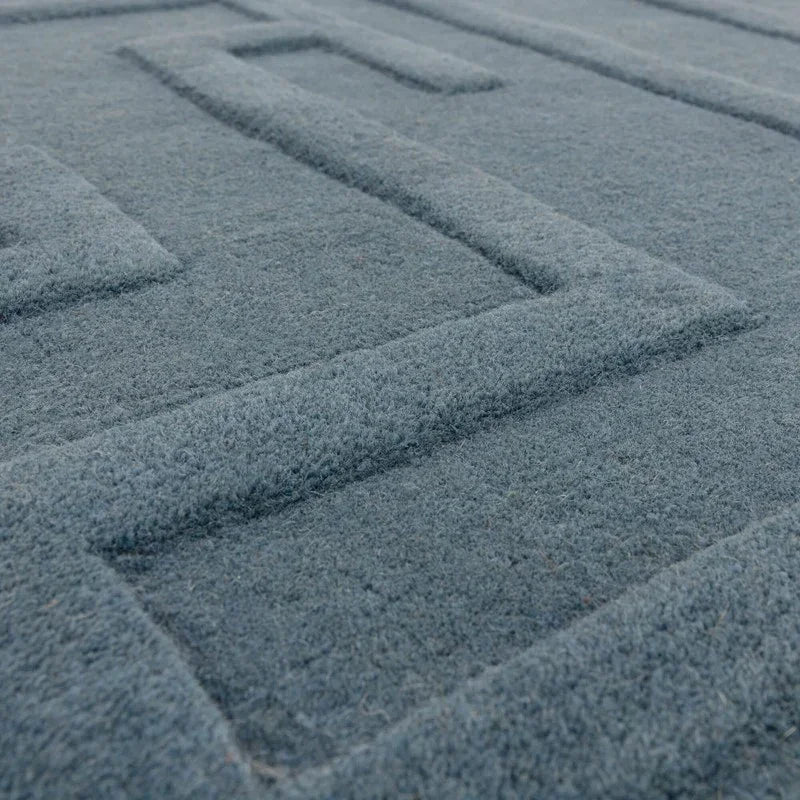Grey wool rug with raised geometric pattern closeup