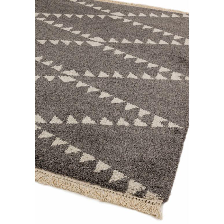 Grey geometric rug with white triangle pattern and fringed edge