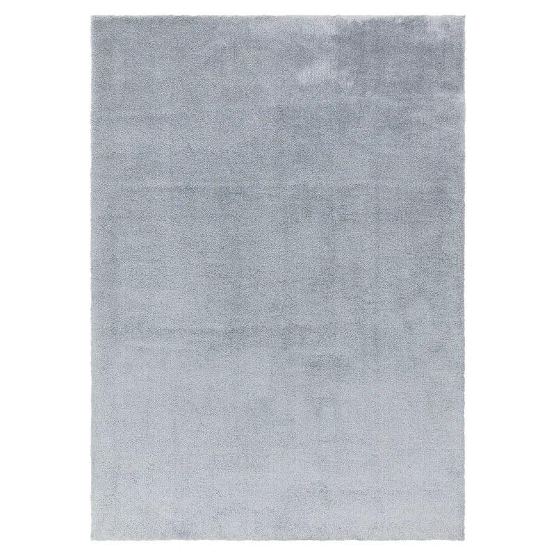 Light grey area rug with soft pile and rectangular shape, viewed from above