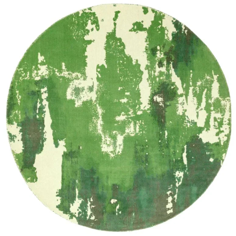 Round area rug with green and cream abstract pattern