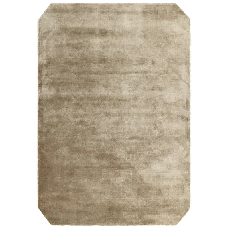 Beige rectangular area rug with cut corners and soft textured finish
