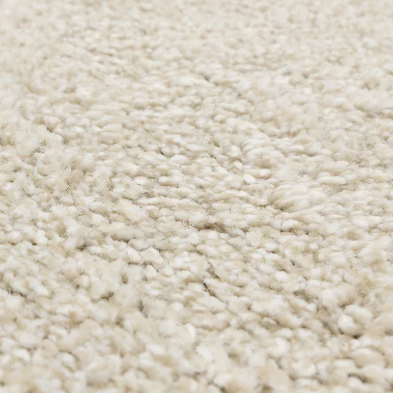 Close up of cream textured carpet showing soft pile and woven detail