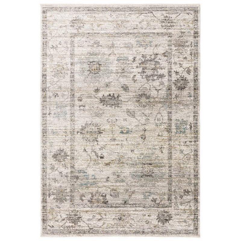 Grey and beige area rug with subtle floral pattern and distressed finish