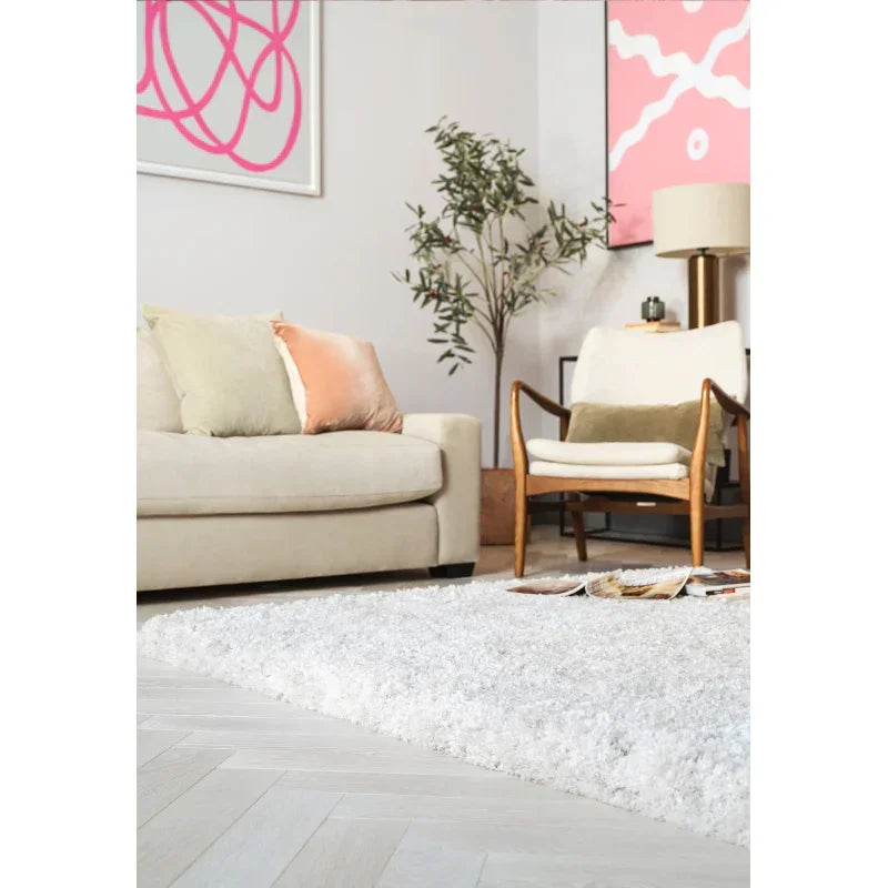Modern living room with cream sofa, wooden accent chair and white shaggy rug