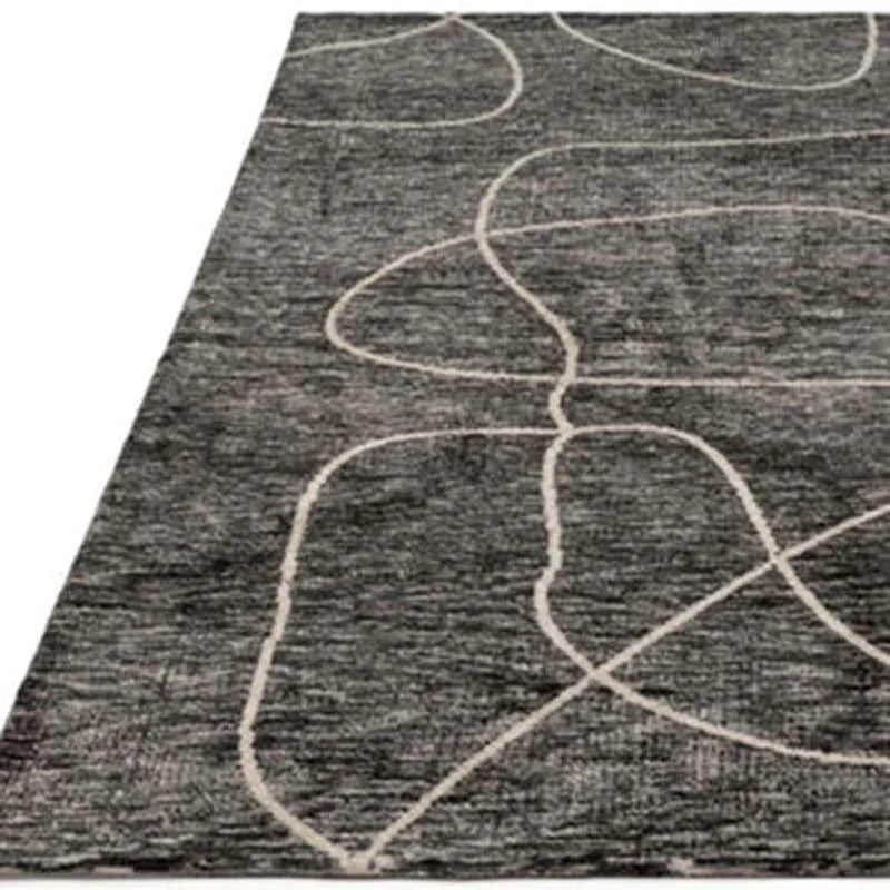 Dark grey area rug with abstract light line pattern and textured surface