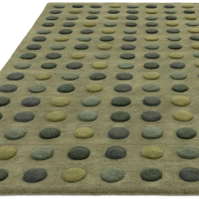 Green wool rug with raised polka dot pattern in multiple shades of green