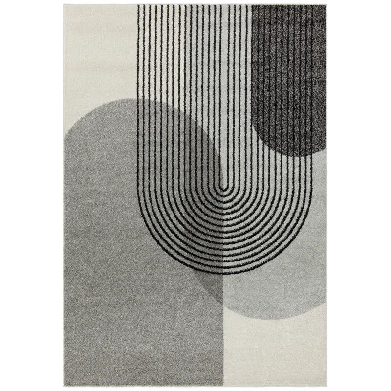 Modern geometric area rug in grey with curved lines and overlapping shapes