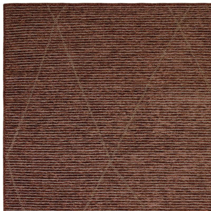 Brown textured area rug with subtle linear and geometric pattern closeup