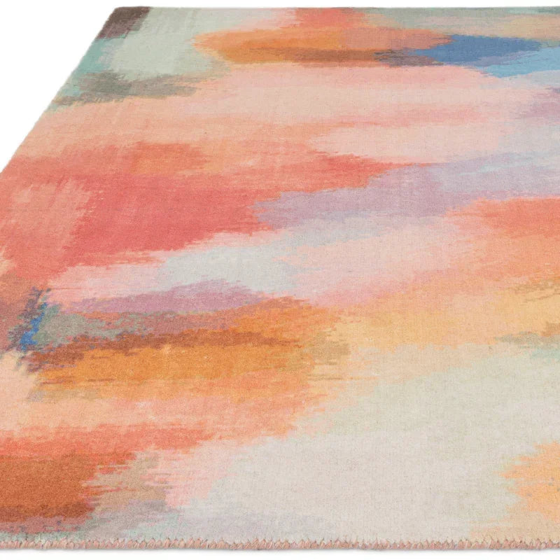Abstract multicolour area rug with soft pastel tones and painterly pattern, angled view