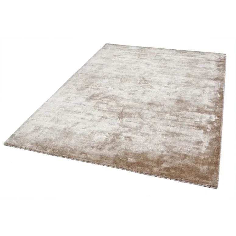 Beige area rug with soft texture and subtle sheen on a white background