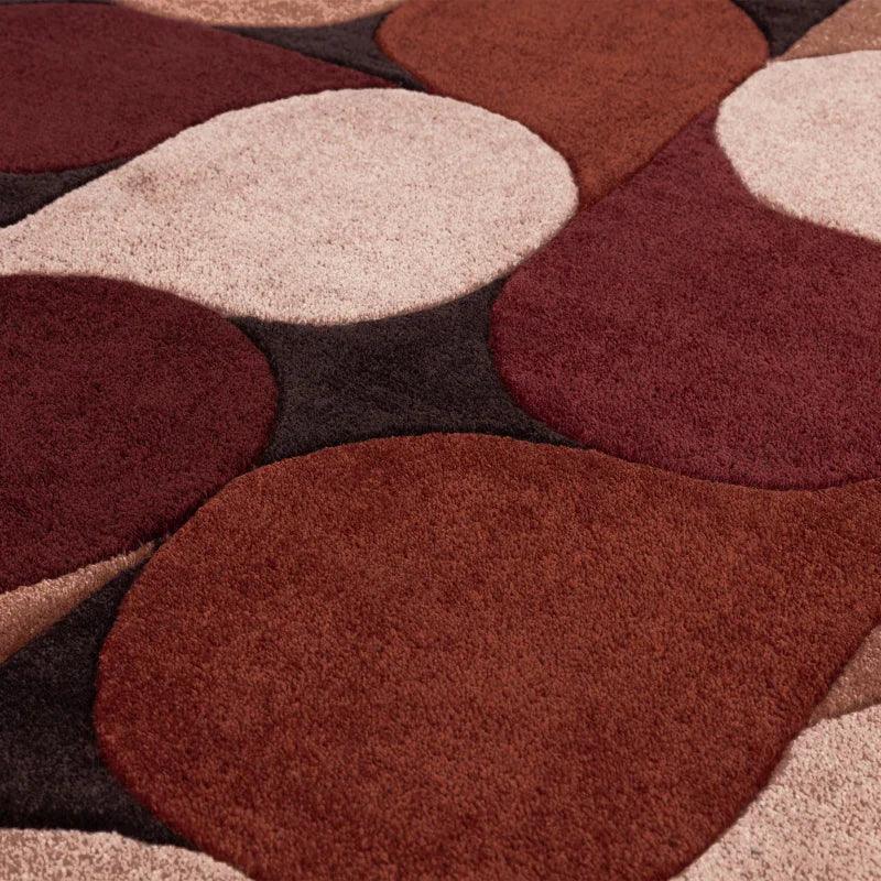 Modern area rug with overlapping circles in brown, beige, and burgundy pile