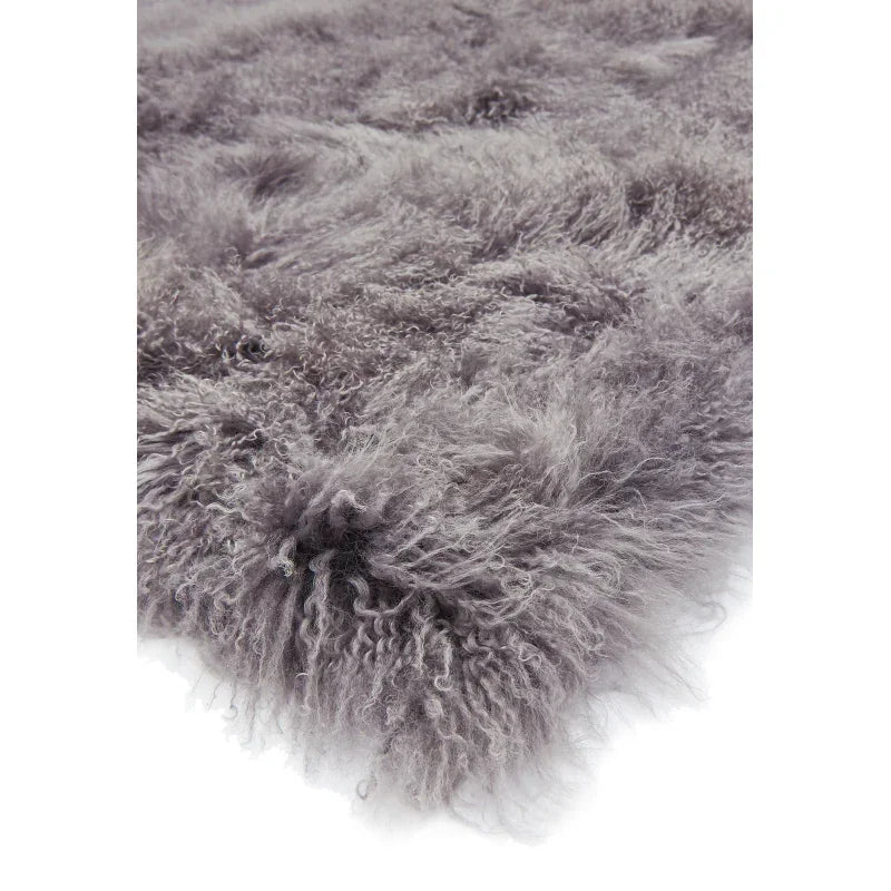 Closeup of grey sheepskin rug with soft, fluffy texture and wavy pile