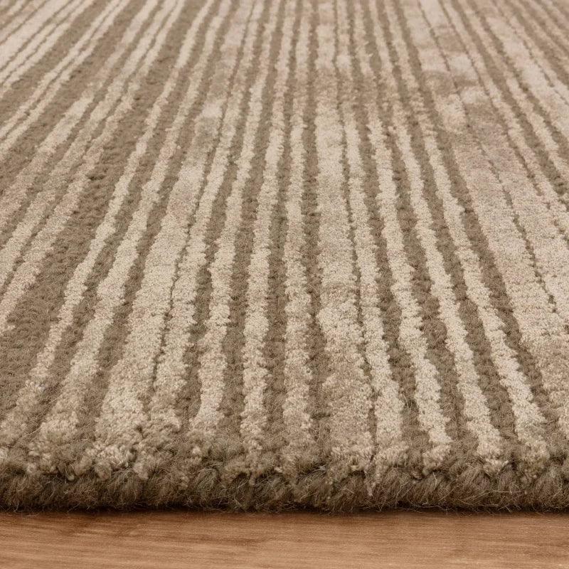 Beige striped area rug with textured pile on wooden floor