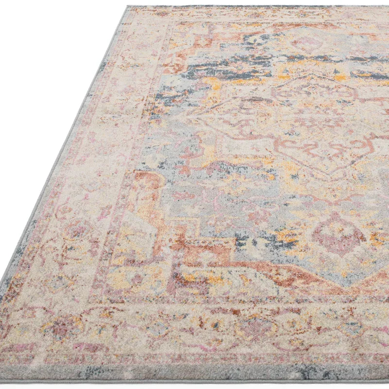 Pastel patterned area rug with distressed vintage design and soft woven texture