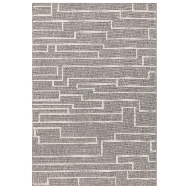 Grey area rug with geometric white line pattern, viewed from above