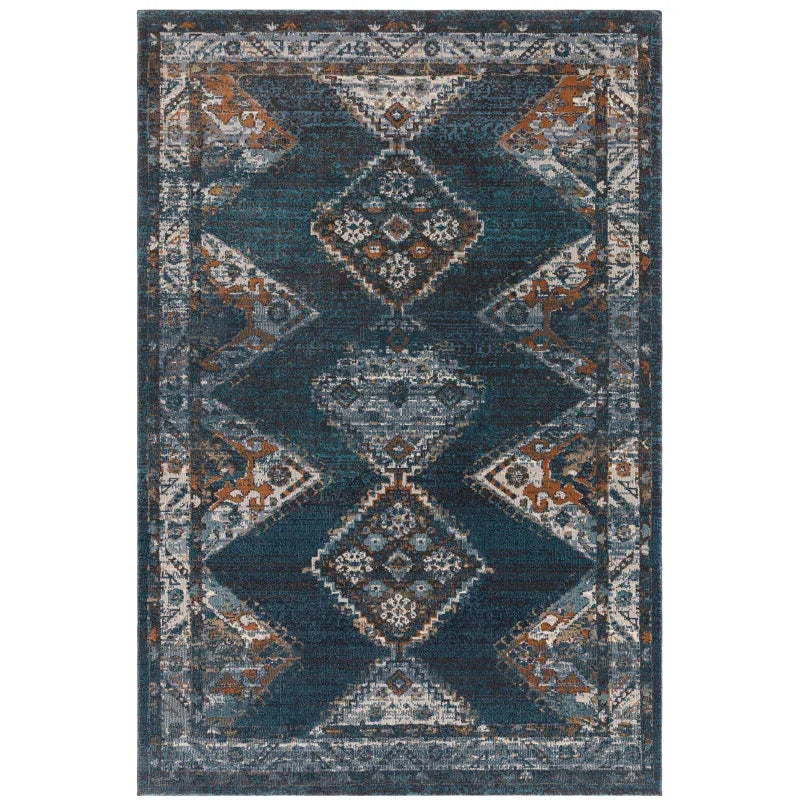Blue and rust geometric patterned area rug with distressed finish