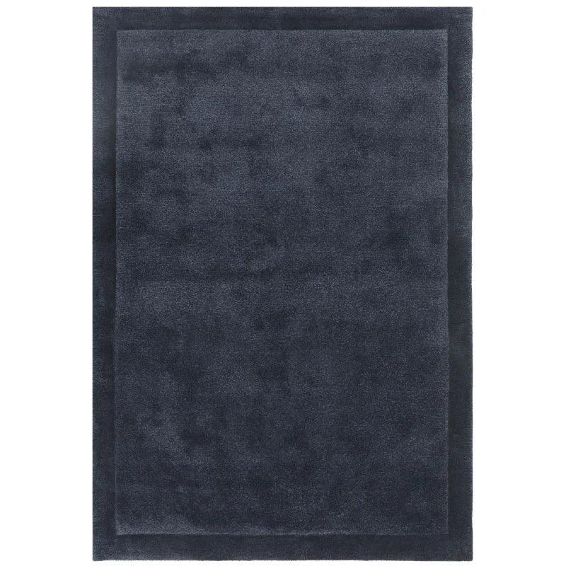 dark grey rectangular area rug with subtle border design