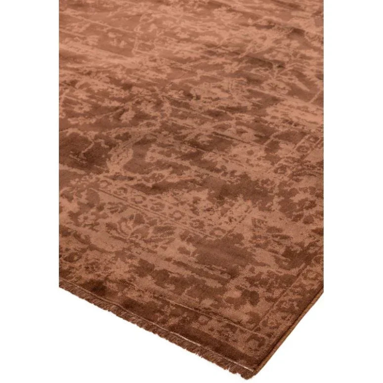 Brown patterned area rug with subtle textured design and finished edge