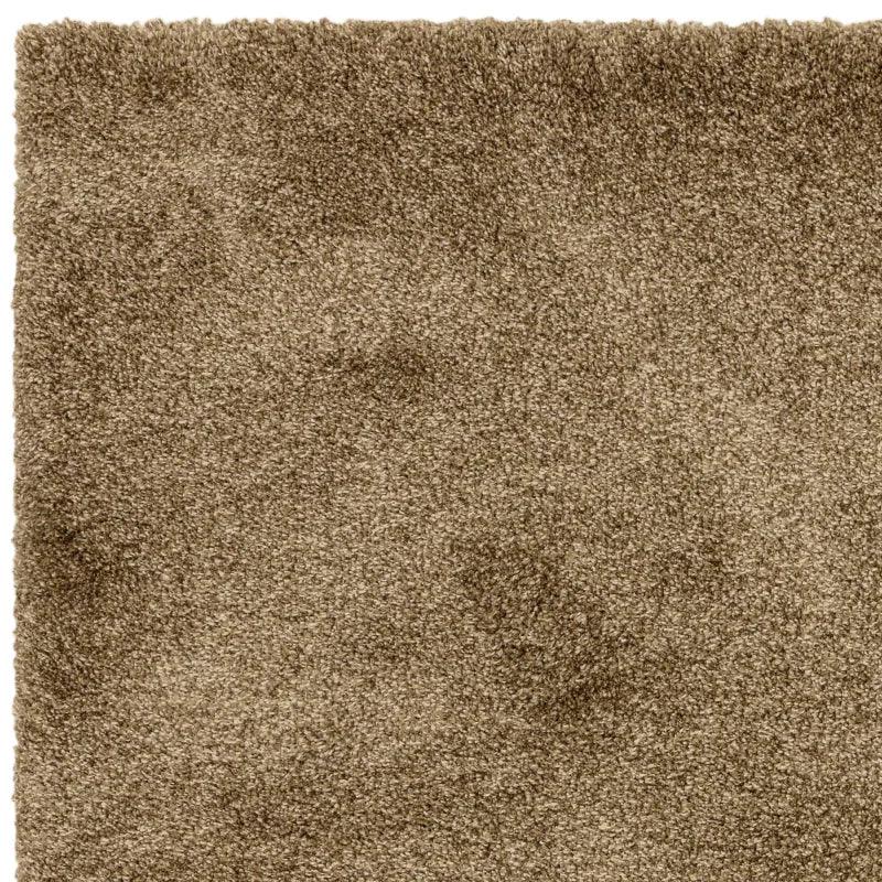 Beige shaggy rug closeup showing thick pile texture and soft material