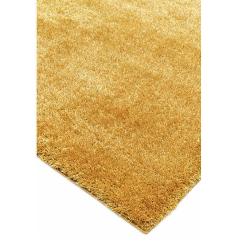 Golden yellow shaggy rug close-up showing soft textured pile and corner detail