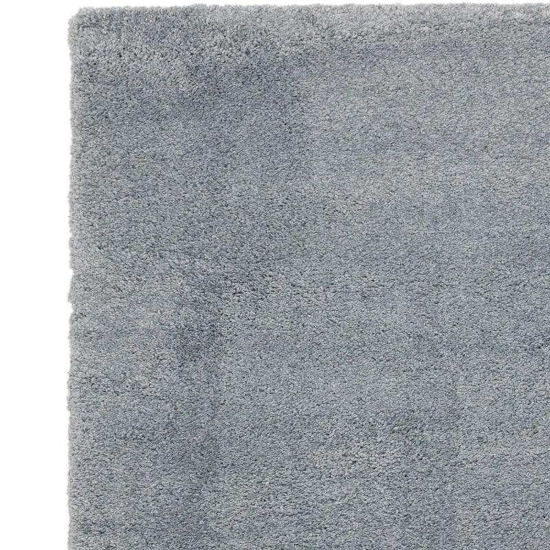Light grey shaggy rug corner showing soft pile texture
