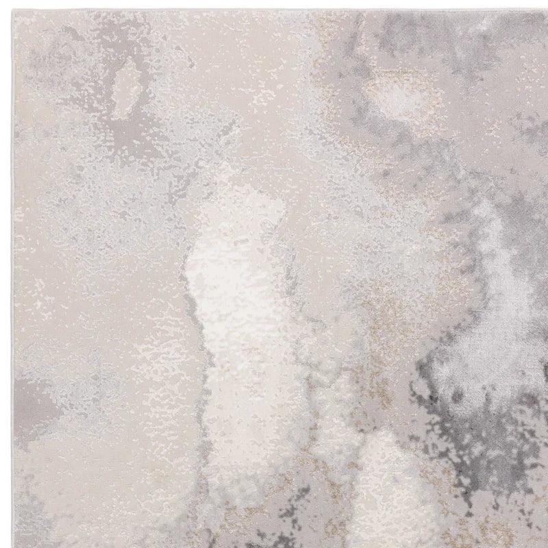Modern area rug with abstract grey and cream pattern, close-up of soft textured surface