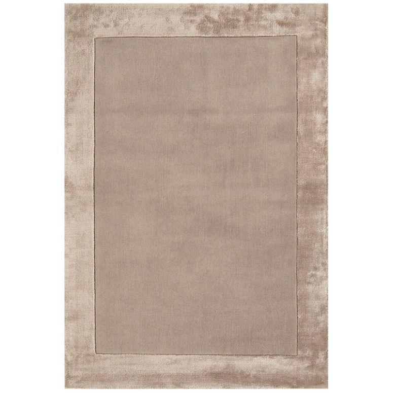 Beige rectangular area rug with plush border and soft texture