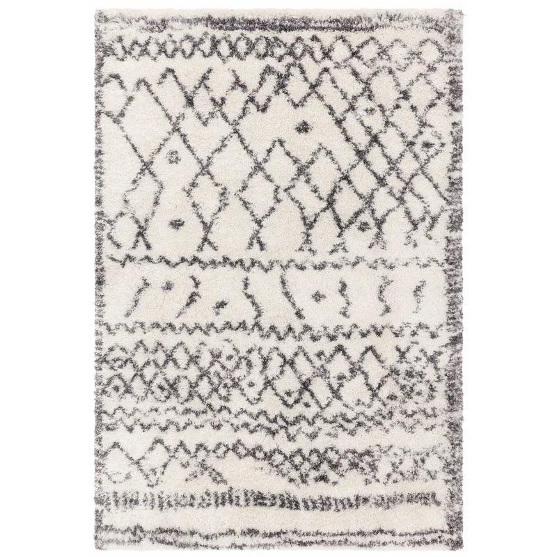 Cream shaggy rug with black tribal geometric pattern and soft textured pile