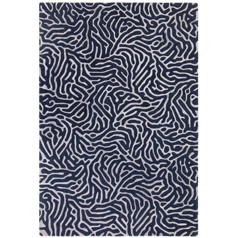 Navy patterned area rug with abstract silver line design