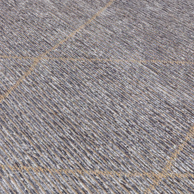 Closeup of grey and beige rug with subtle geometric line pattern and textured surface