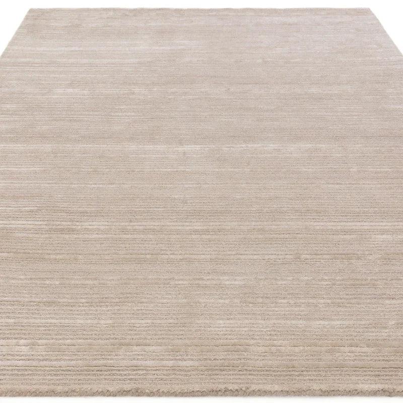 Beige textured area rug with subtle linear pattern and soft finish, viewed from above