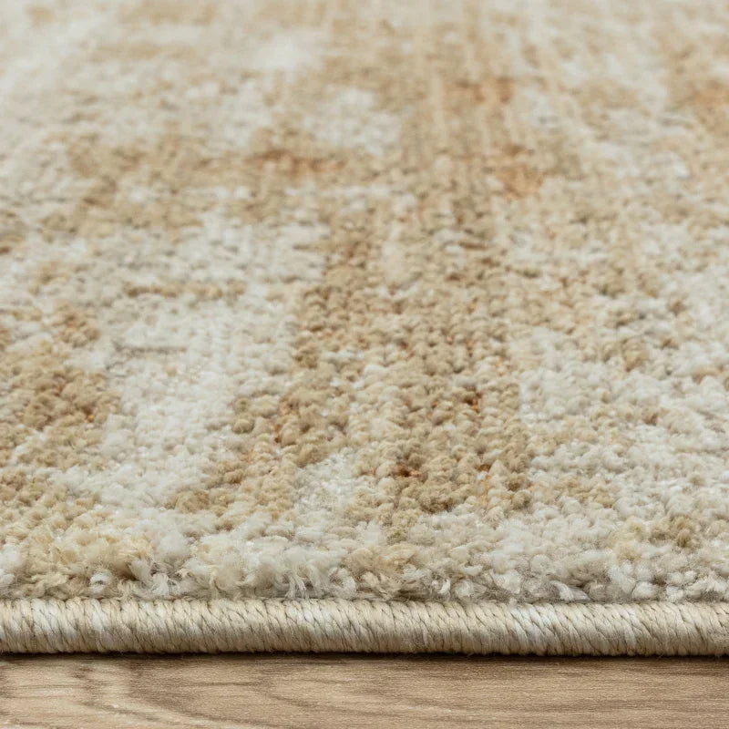 Close-up of beige patterned rug texture on wooden floor