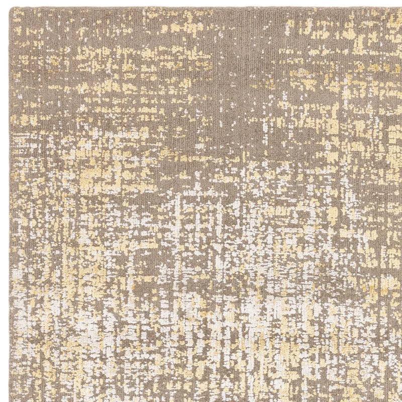 Beige and cream abstract pattern area rug closeup showing textured fibre details