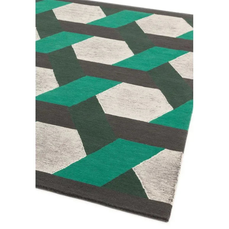 Geometric wool rug with green, grey, and white pattern viewed from an angle